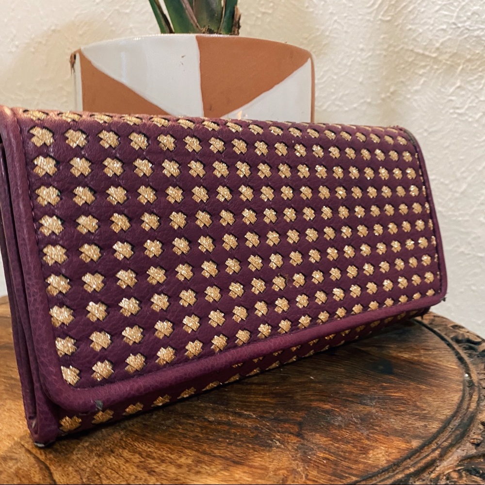 Purple and gold clutch bag